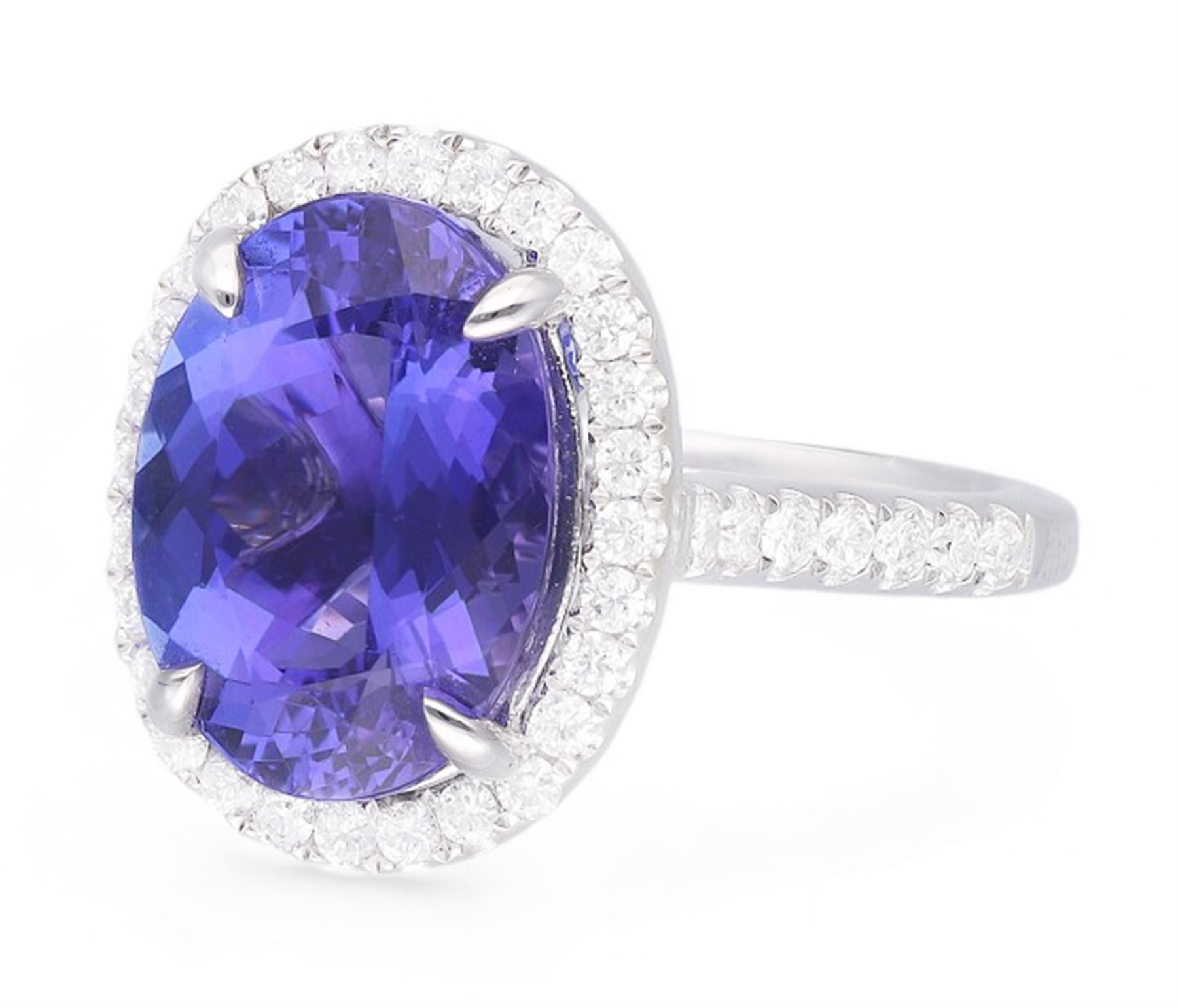 18ct white gold oval cut tanzanite and round brilliant cut diamond cluster ring, with diamond set shoulders, hallmarked, tanzanite 5.83 carat, total diamond weight 0.54 carat