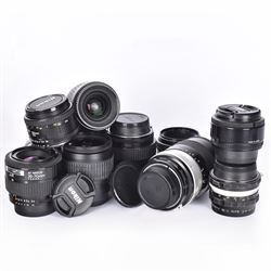 Eleven Nikon camera lenses, including AF Nikkor 35-70mm 1:3.5-4.5, nikkor-Q Auto 1:2.8 f=135mm and a Nikkor-HC Auto 1:3.5 f=28mm 