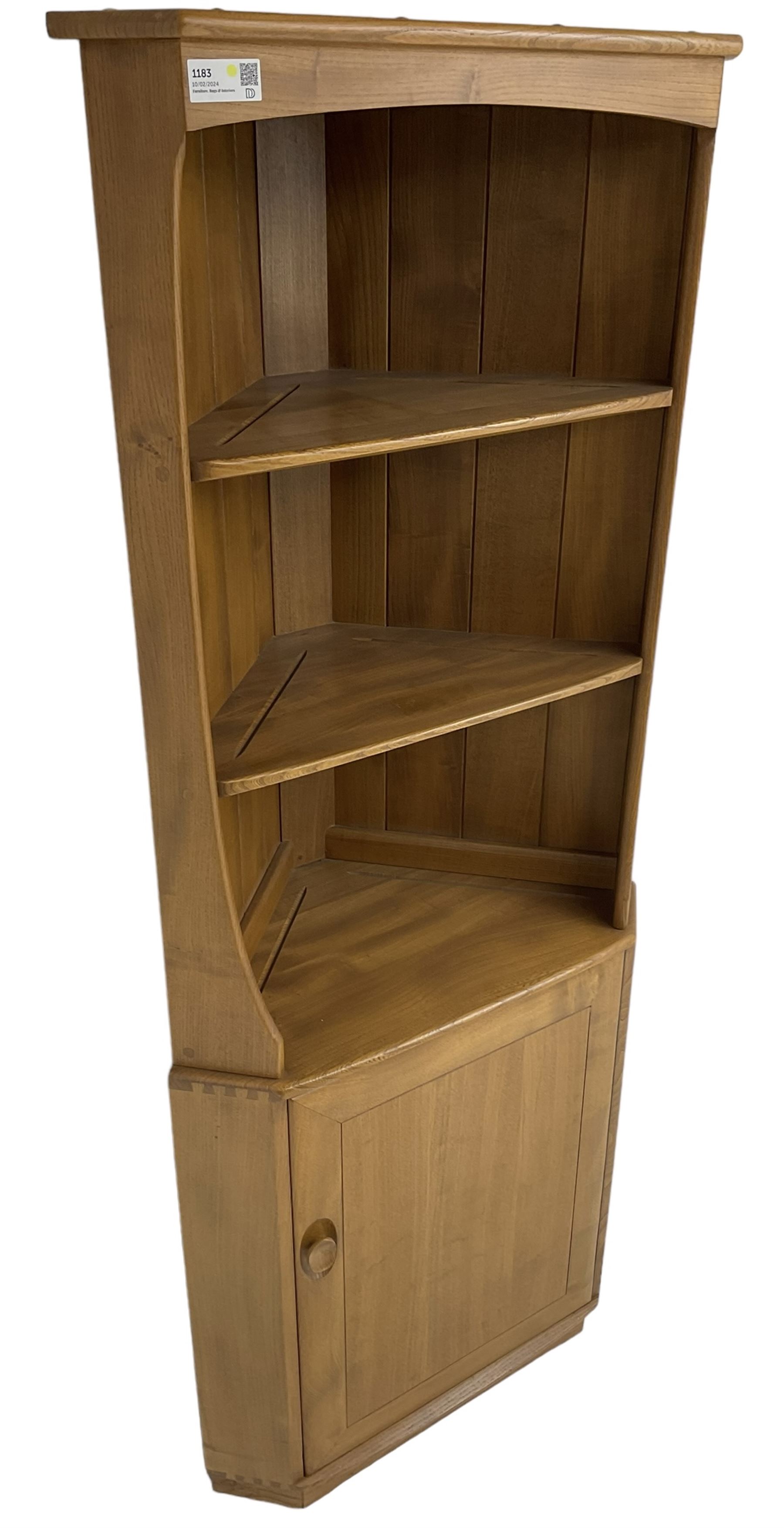 Ercol - mid-20th century '743C'  light elm corner cabinet, fitted with two open shelves over a single cupboard