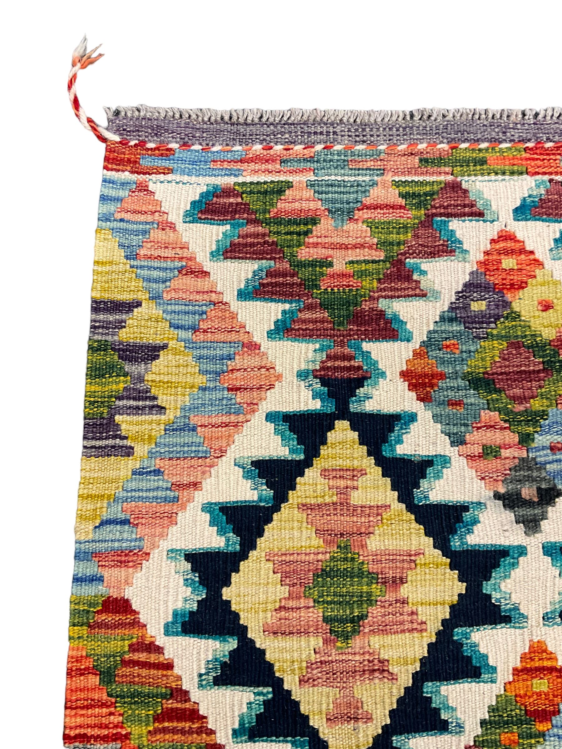 Chobi Kilim rug, over geometric design, decorated with multi-coloured stepped lozenges