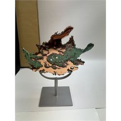 Free form copper splash, with green patina and polished copper accents, upon a silver metal stand, H20cm 