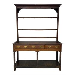 18th century oak dresser, raised three tier plate rack with moulded cresting rail, rectangular top over three drawers, the drawer fronts with moulded edges, turned supports united by pot board base 