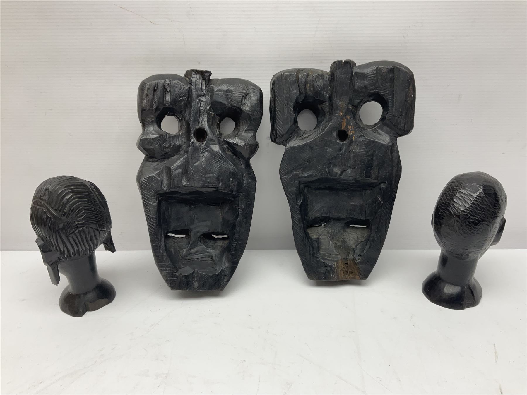 Two African tribal daggers, four carved masks/busts and similar collectables