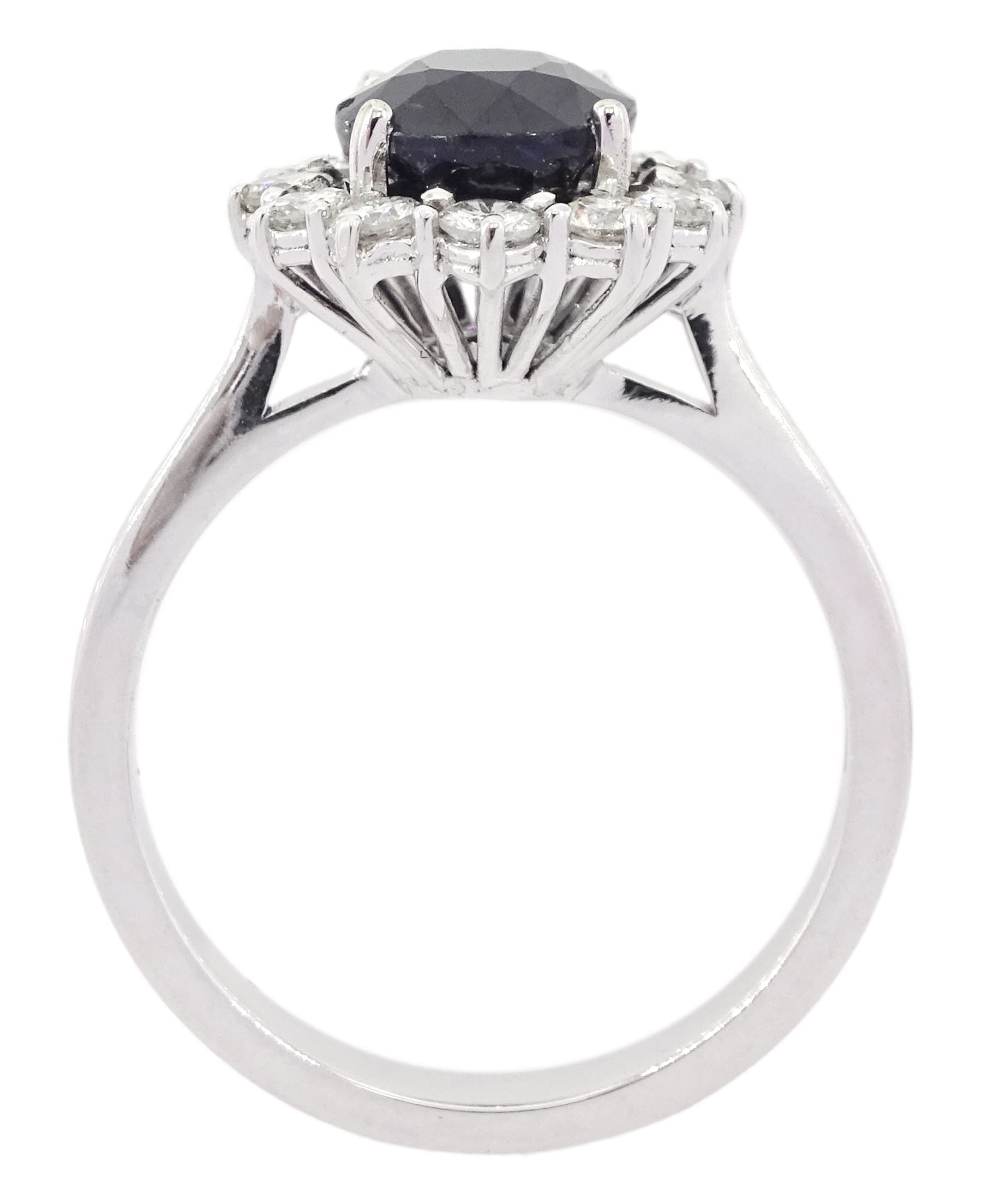 18ct white gold oval cut sapphire and round brilliant cut diamond cluster ring, hallmarked, sapphire approx 2.60 carat, total diamond weight approx 0.55 carat