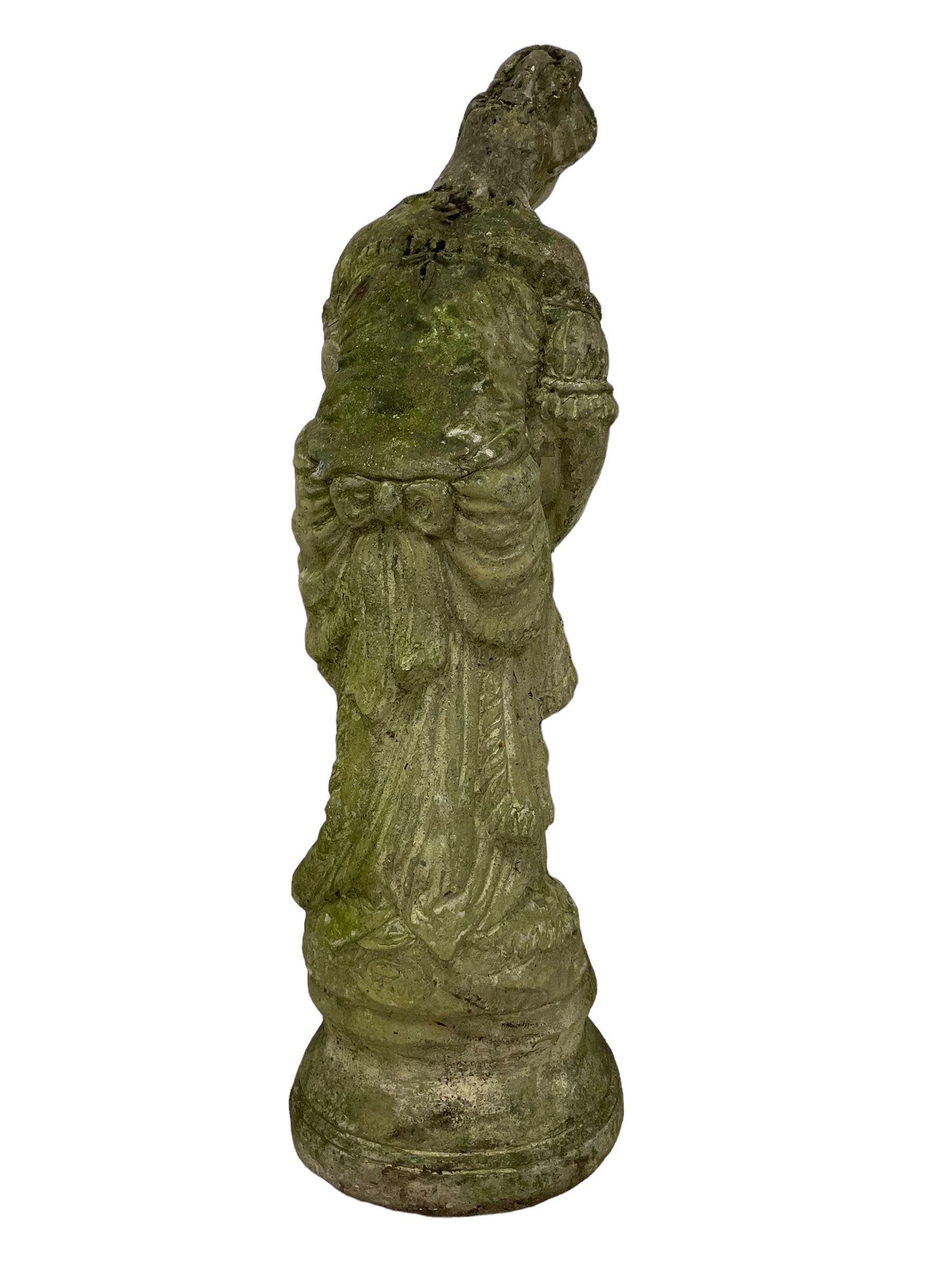 Weathered and painted cast stone garden statue, in the form of an Italian maiden with an ornate tied hairstyle and flowing gown, holding a wounded dove, on a turned base with garland decoration