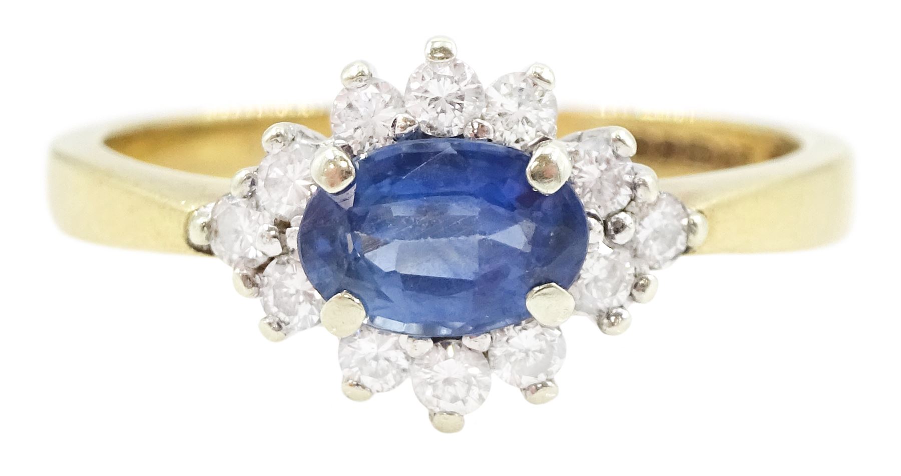 9ct gold oval sapphire and round brilliant cut diamond cluster ring, hallmarked London 1994, sapphire approx 0.55 carat, total diamond weight approx 0.25 carat