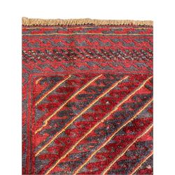 Meshwani indigo and maroon ground rug, the field decorated with a central lozenge with concentric borders containing hook motifs, enclosed by geometric zig-zag guard lines