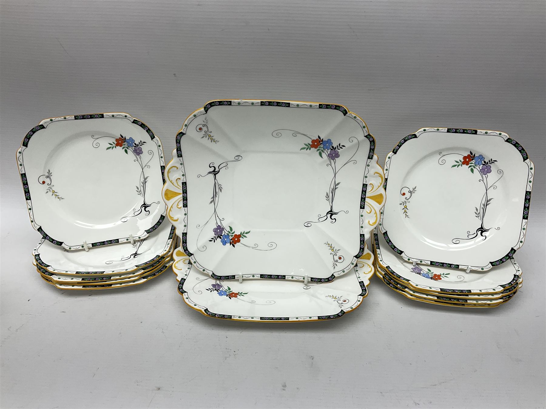 Art deco Shelley tea service for eight, decorated with floral sprigs, comprising teacup and saucers, dessert plates, two cake plates, milk jug and open sucrier, with to extra dessert plates