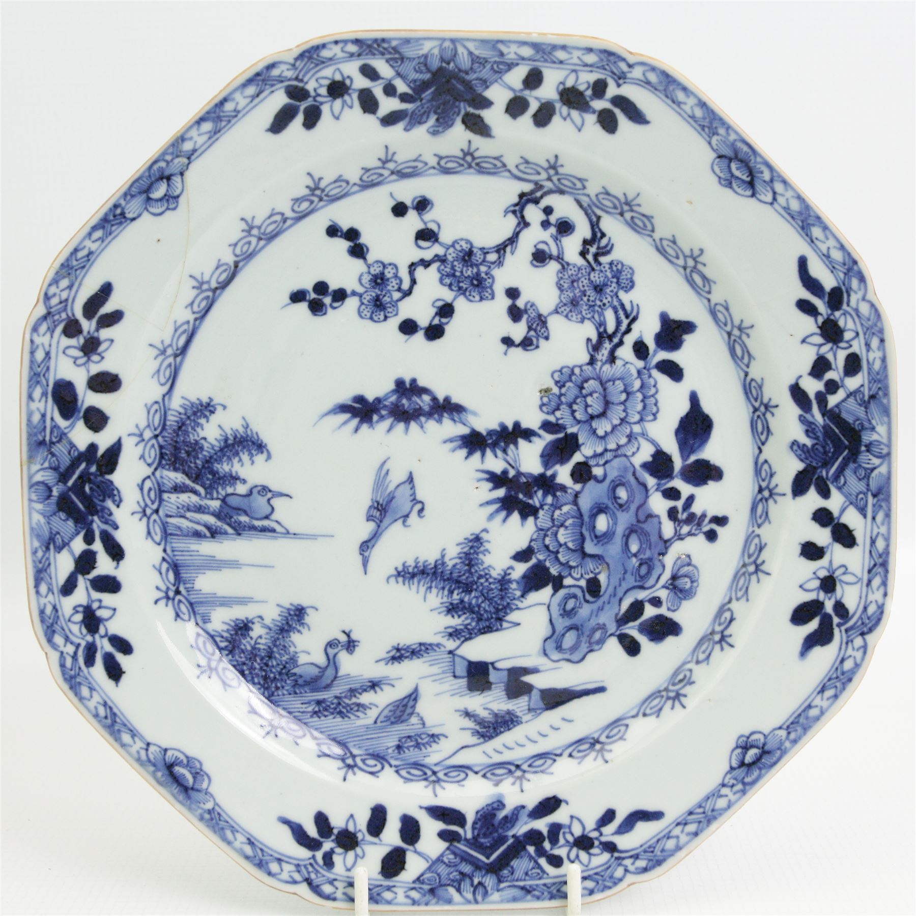 Pair of 18th century Chinese Export octagonal form blue and white plates, together with a similar plate, centrally decorated in polychrome enamels with a landscape scene, W22cm (3)