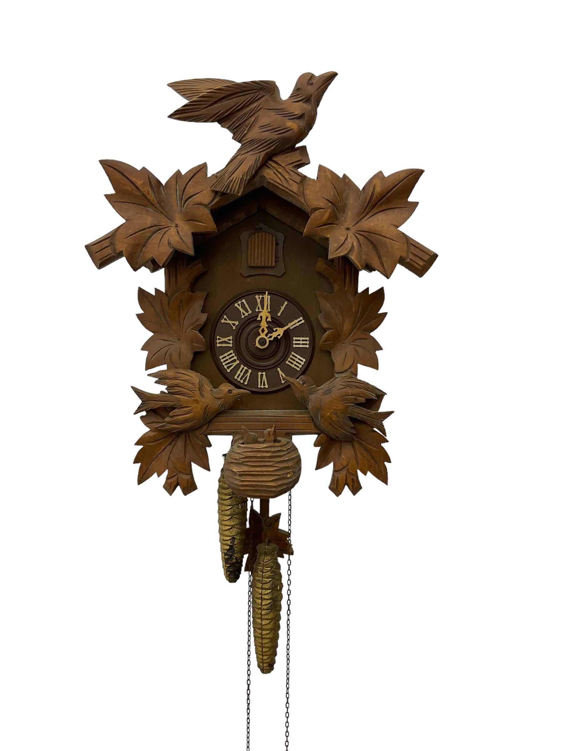 German 1960's cuckoo clock with automata - traditional styled case and dial with a cuckoo sounding the hours and half-hours, twin chain driven movement and automata feature of two carved cuckoos to the front of the case simultaneously moving as the hours are struck. With weights and pendulum.  