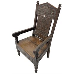 17th century design oak wainscot chair, the back profusely carved with scrolling foliate motifs, the arms carved with repeating guilloche decoration over an arcade apron and turned supports