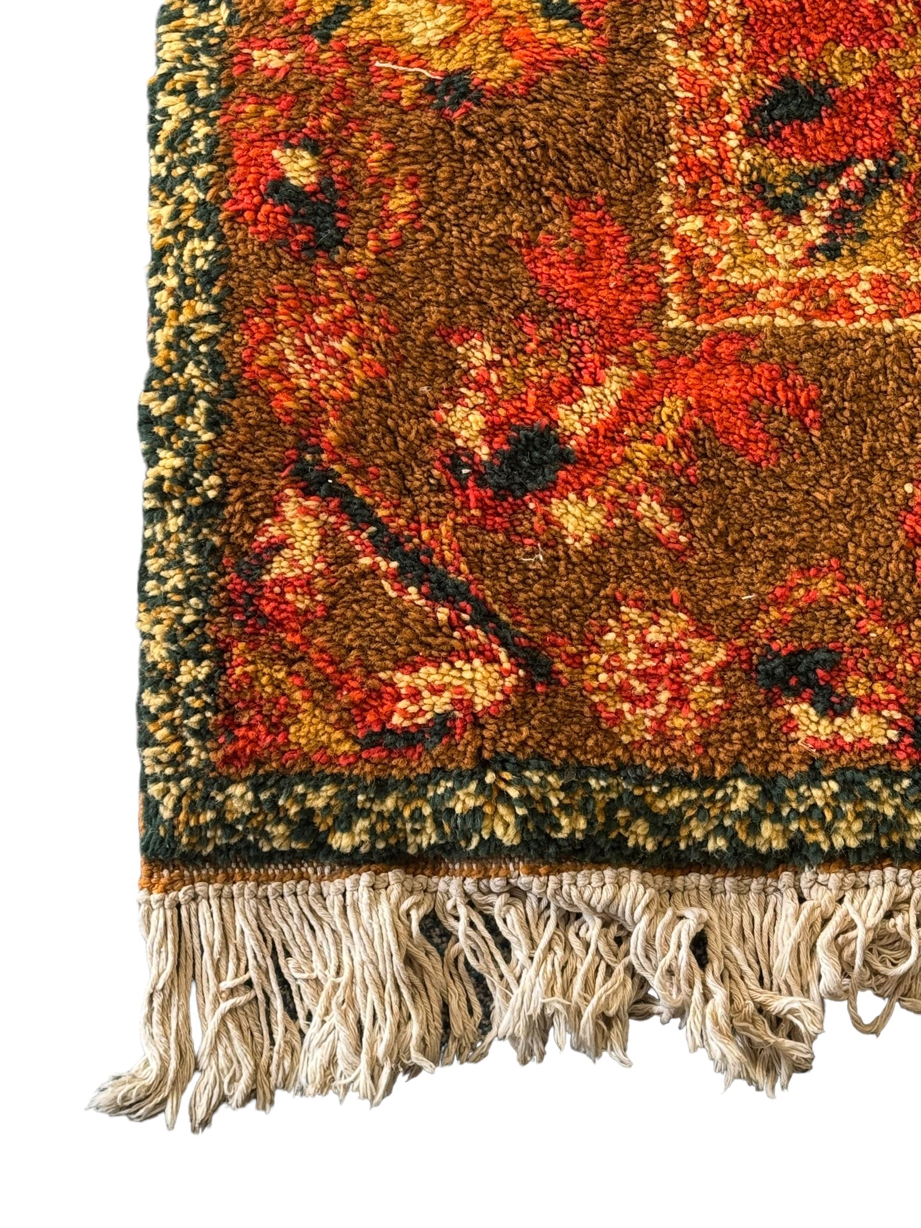 Moroccan amber ground thick pile rug, the plain ivory field decorated with a central pole medallion of star form, the wide guard bands decorated with repeating geometric and foliate patterns