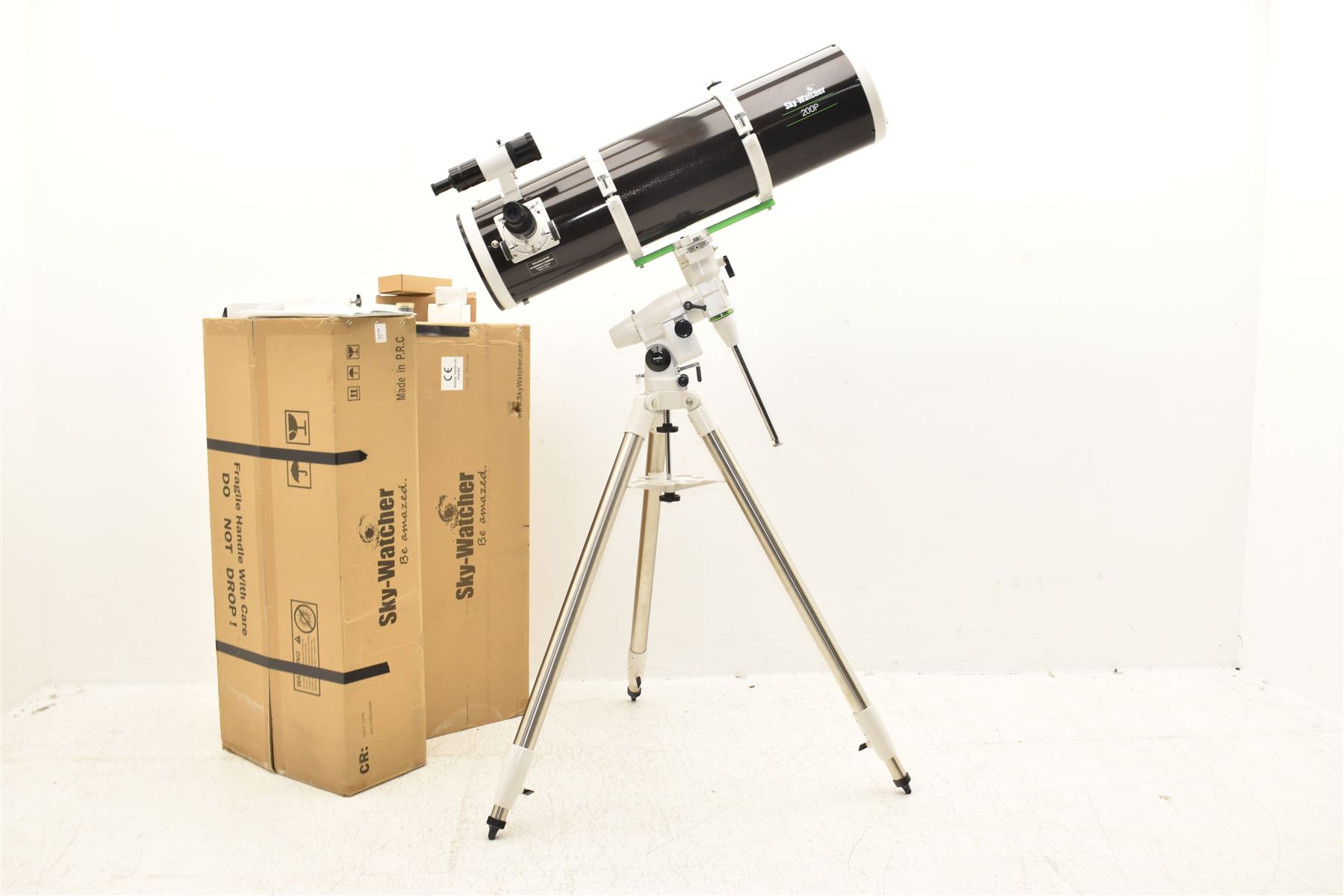 Sky Watcher 200P Newtonian 10” reflector telescope, NEQ3 tripod with counter weights, equatorial mount and finder scope, with a basic 1.25” smartphone adapter and accessories including a Super 10 long eye relief , Celestron 10mm lens, 2 x 1. Barlow lens and super 25 wide angle long eye relief lens. With assembly instruction manual and astronomical telescope user guide.