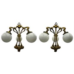 Pair of Art Nouveau design gilt metal ceiling lights, each with three stems connecting glass dome