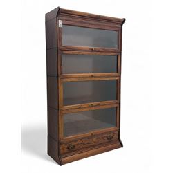 Early 20th century oak stacking library bookcase, four sections enclosed by hinged and sli...