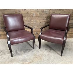 Two rosewood framed armchairs, upholstered in brown leather