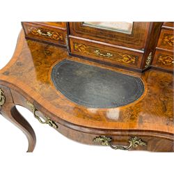 19th century French figured walnut Bonheur de Jour or writing desk, the upper section with brass gallery over mirror glazed cupboard and a combination of drawers, shaped and moulded top with leather inset and satinwood band, fitted with single drawer, on cabriole supports, inlaid throughout with scrolling foliate decoration in boxwood, ornate cast brass mounts 