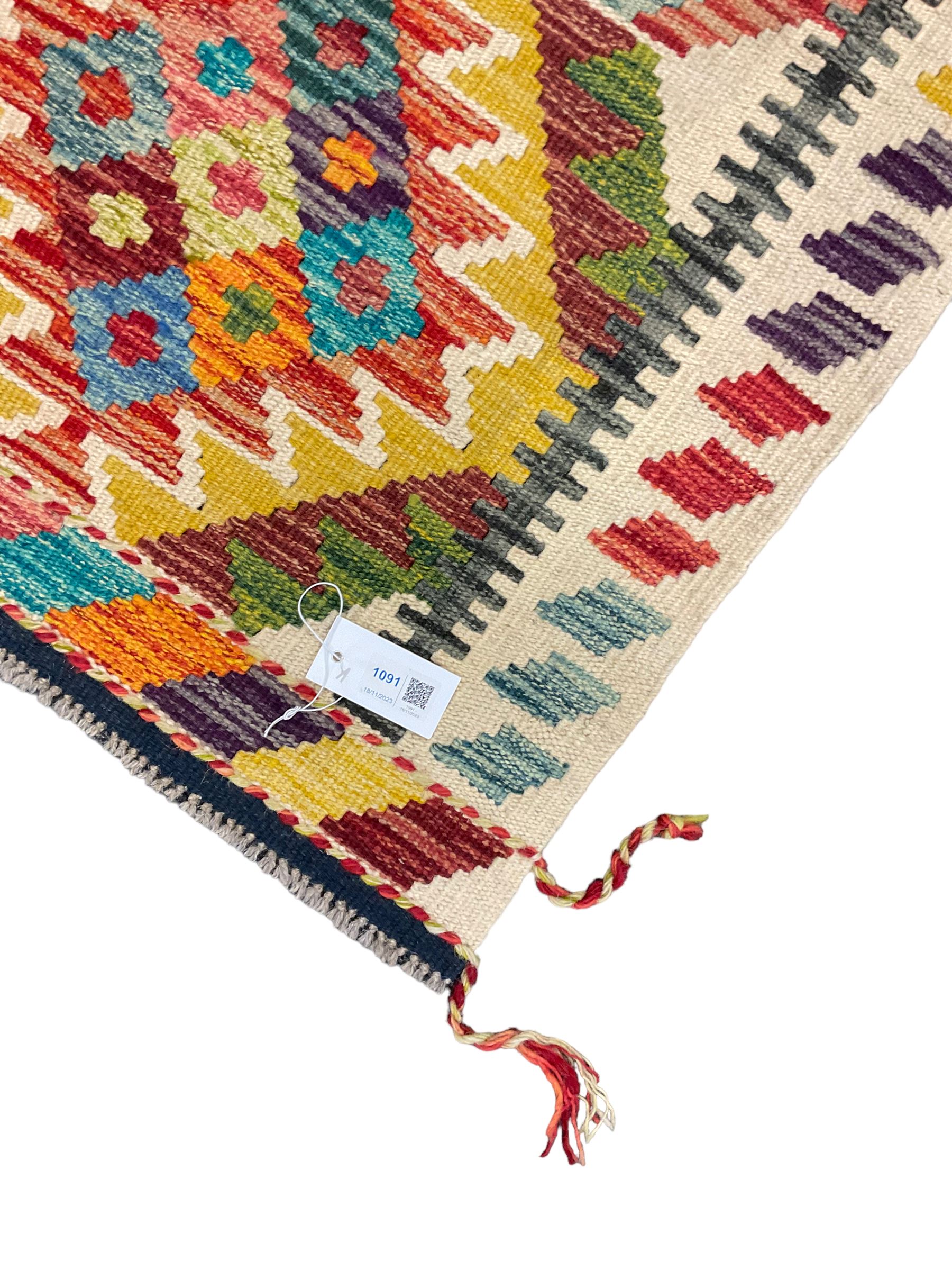 Chobi Kilim rug, pale ground and decorated with multi-coloured geometric pattern 