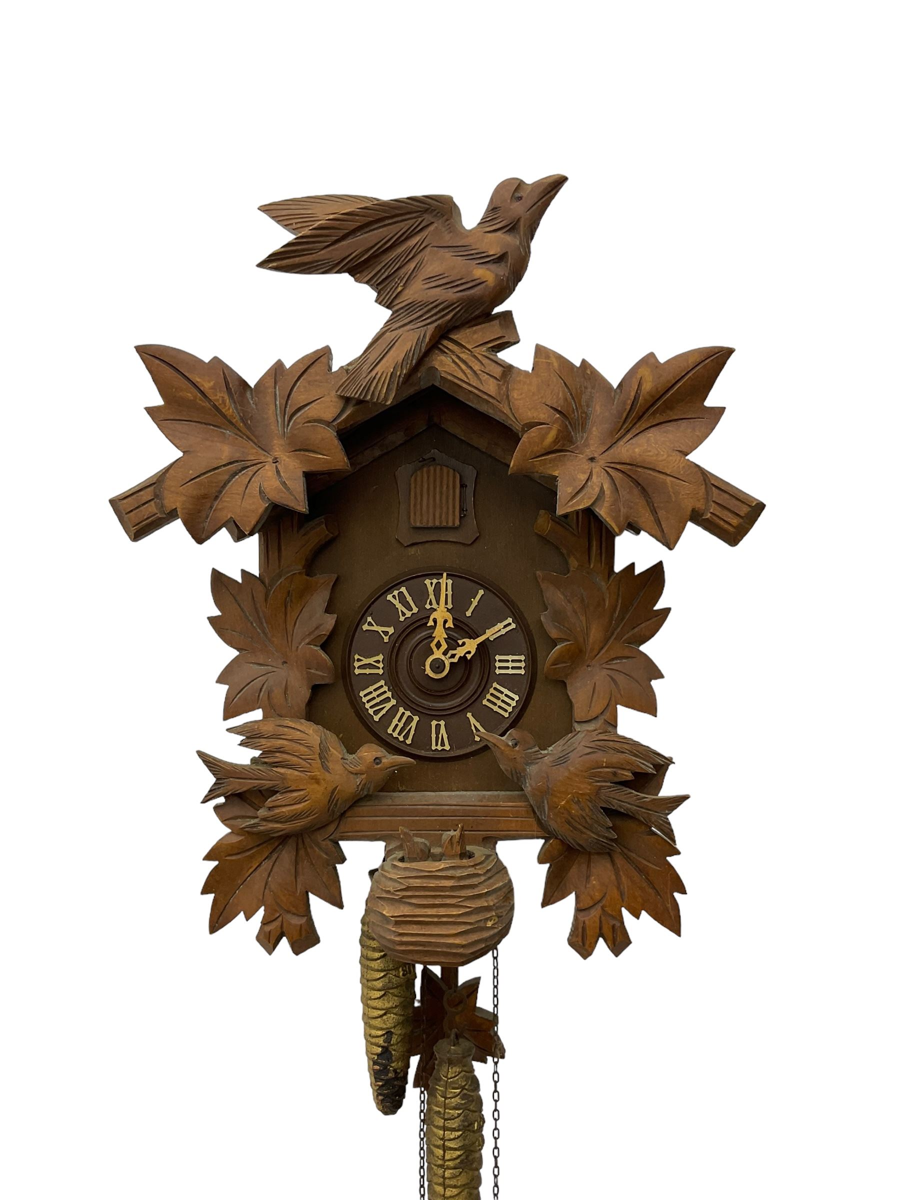 German 1960's cuckoo clock with automata - traditional styled case and dial with a cuckoo sounding the hours and half-hours, twin chain driven movement and automata feature of two carved cuckoos to the front of the case simultaneously moving as the hours are struck. With weights and pendulum.  