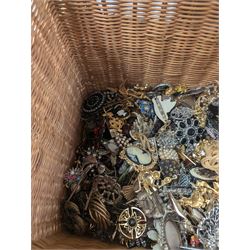 Collection of costume brooches, including ceramic, novelty and animal examples, contained within an wicker basket box