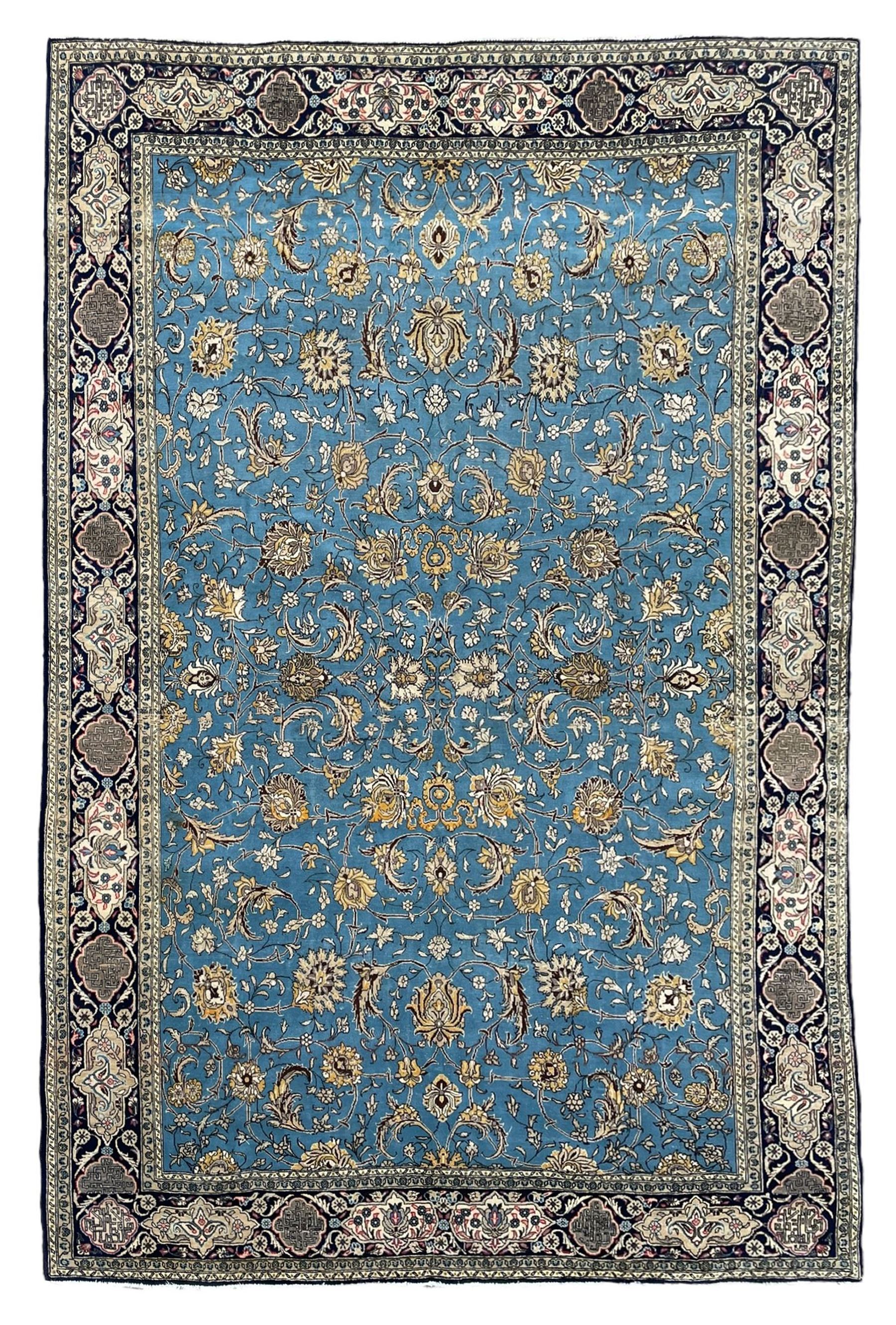 Persian Nain blue ground rug, overall arabesque design, the busy field decorated with interlacing branches and palmettes, indigo ground border with panels decorated with knots and lotus flower motifs, surrounded by trailing branches and flower heads, within guard stripes