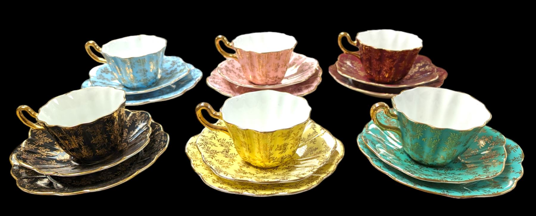 Set of six Royal Stuart Spencer Stevenson Harlequin cup and saucer trios, with gilt floral decoration 