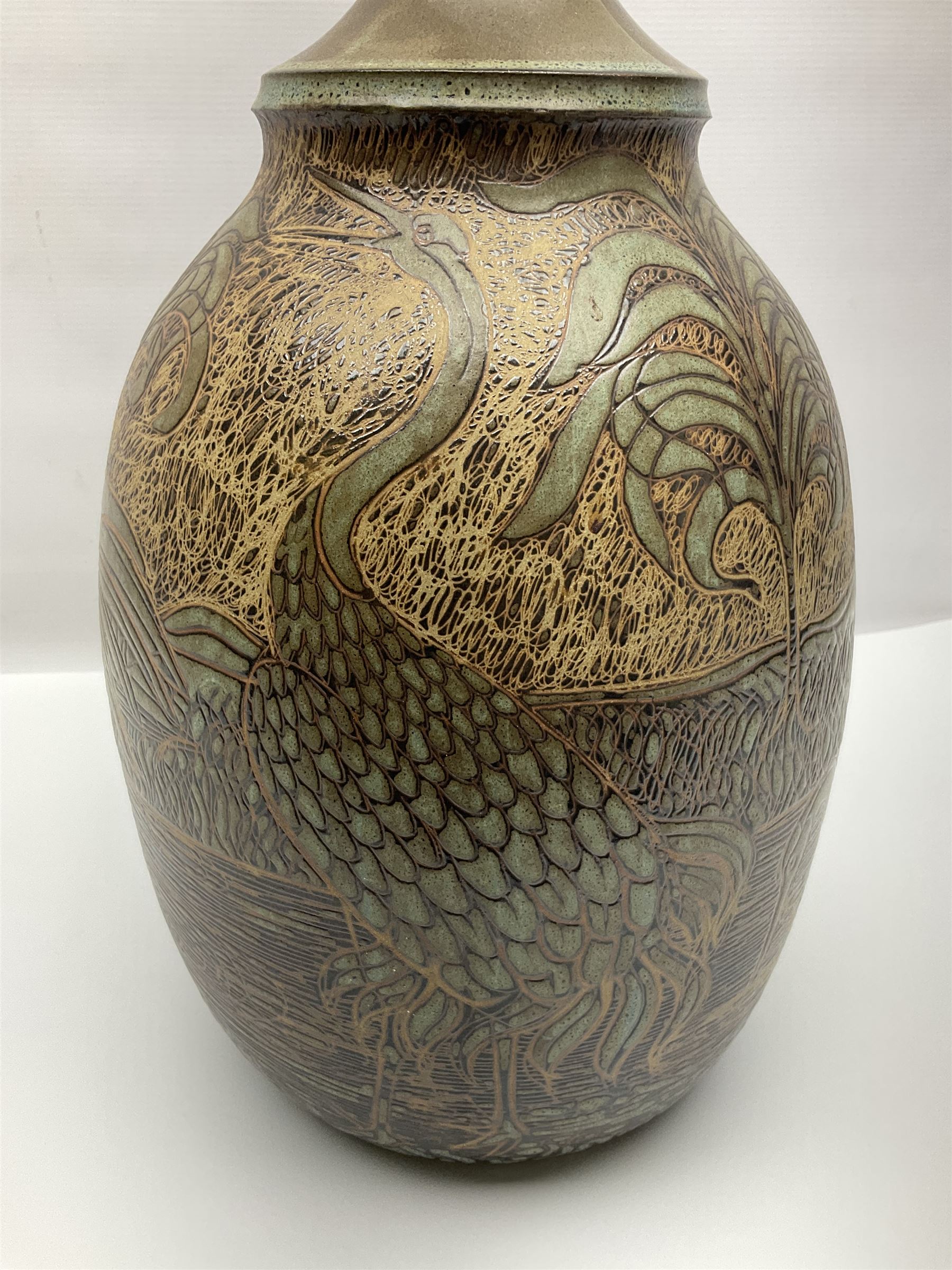 John Egerton (c1945-): studio pottery stoneware lamp base, decorated with cranes in a riverscape upon a mottled brown ground, H51cm