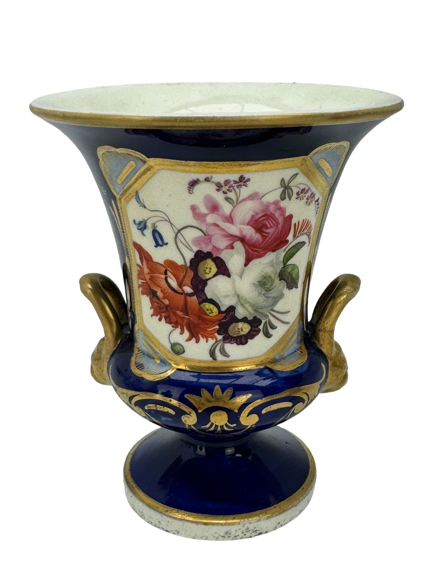 Samuel Alcock porcelain vase of footed two-handled form decorated with a panel of flowers and landscape verso, H16cm, 19th century porcelain vase with flared petal shaped rim, hand painted with a still life of shells, against a cobalt blue and gilt ground, small porcelain basket hand painted with a figure, and campana shaped urn (4)