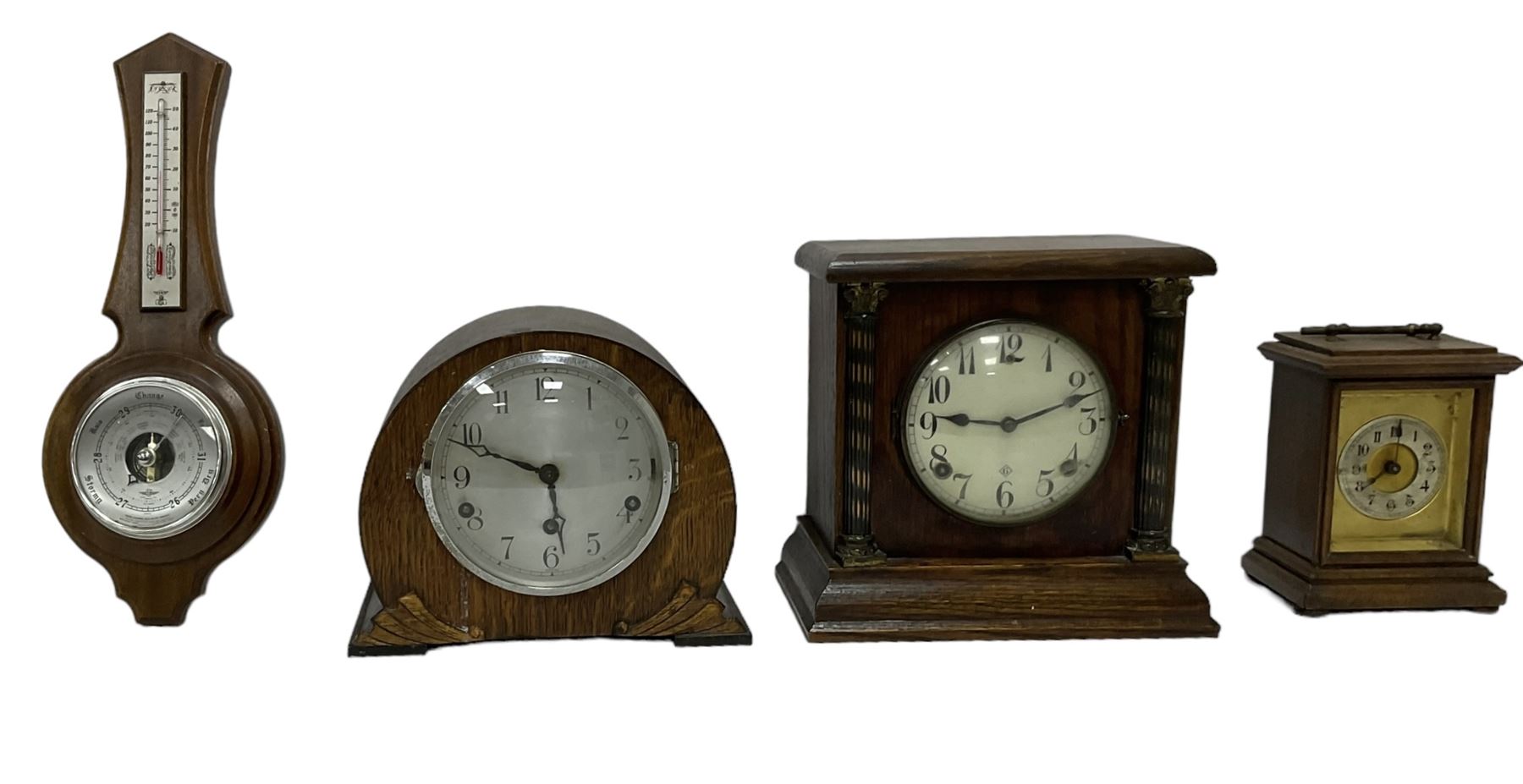 Assortment of three mantle clocks and an aneroid barometer.