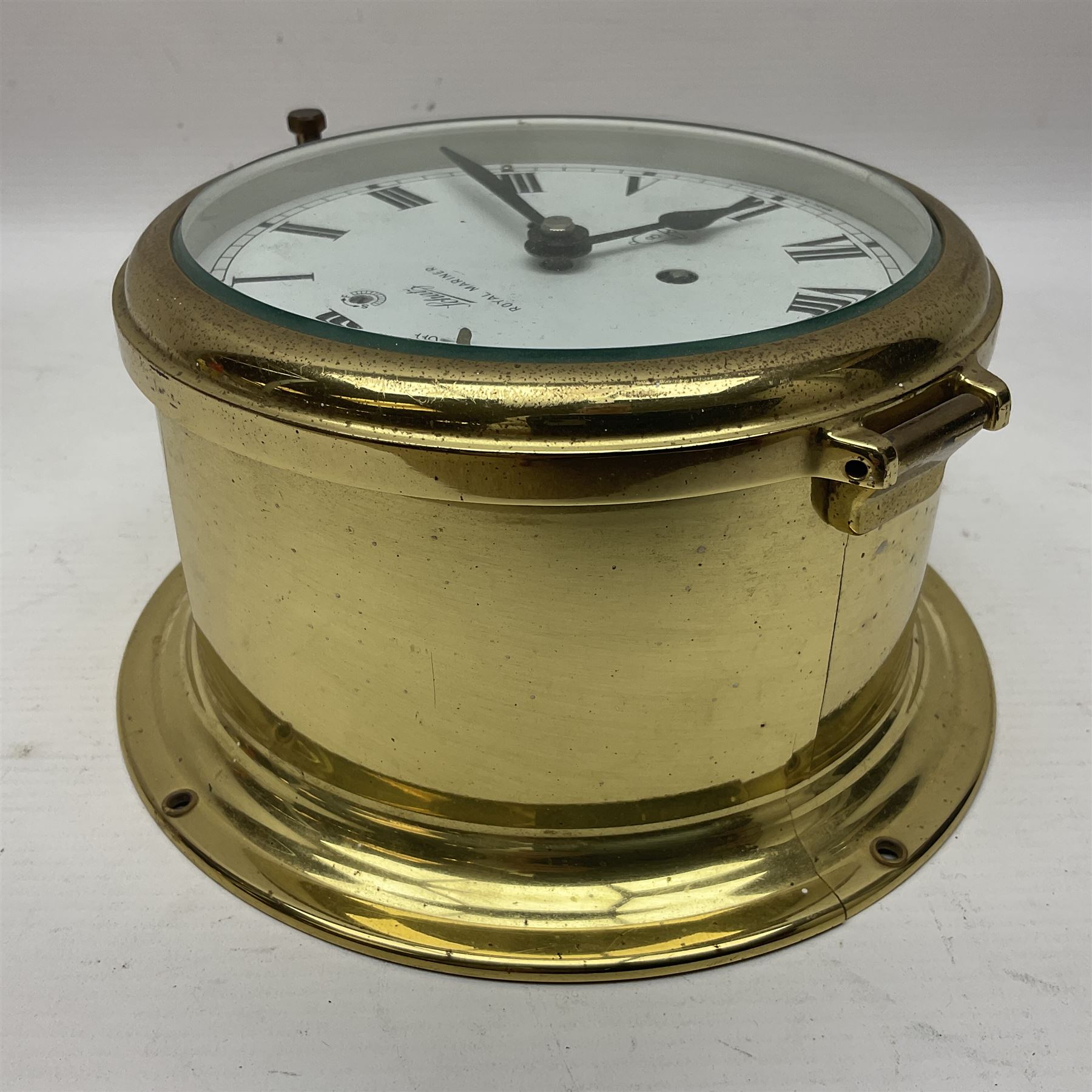 German Schatz Royal Mariner bulkhead ships clock, with an eight-day two-train platform seven-jewel movement, striking the ship's watch on a bell, with bells on/off facility and platform regulation on the 5 inch painted dial, with roman numerals and minute track, in brass case, case D16cm