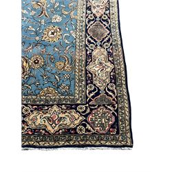 Persian Nain blue ground rug, overall arabesque design, the busy field decorated with interlacing branches and palmettes, indigo ground border with panels decorated with knots and lotus flower motifs, surrounded by trailing branches and flower heads, within guard stripes