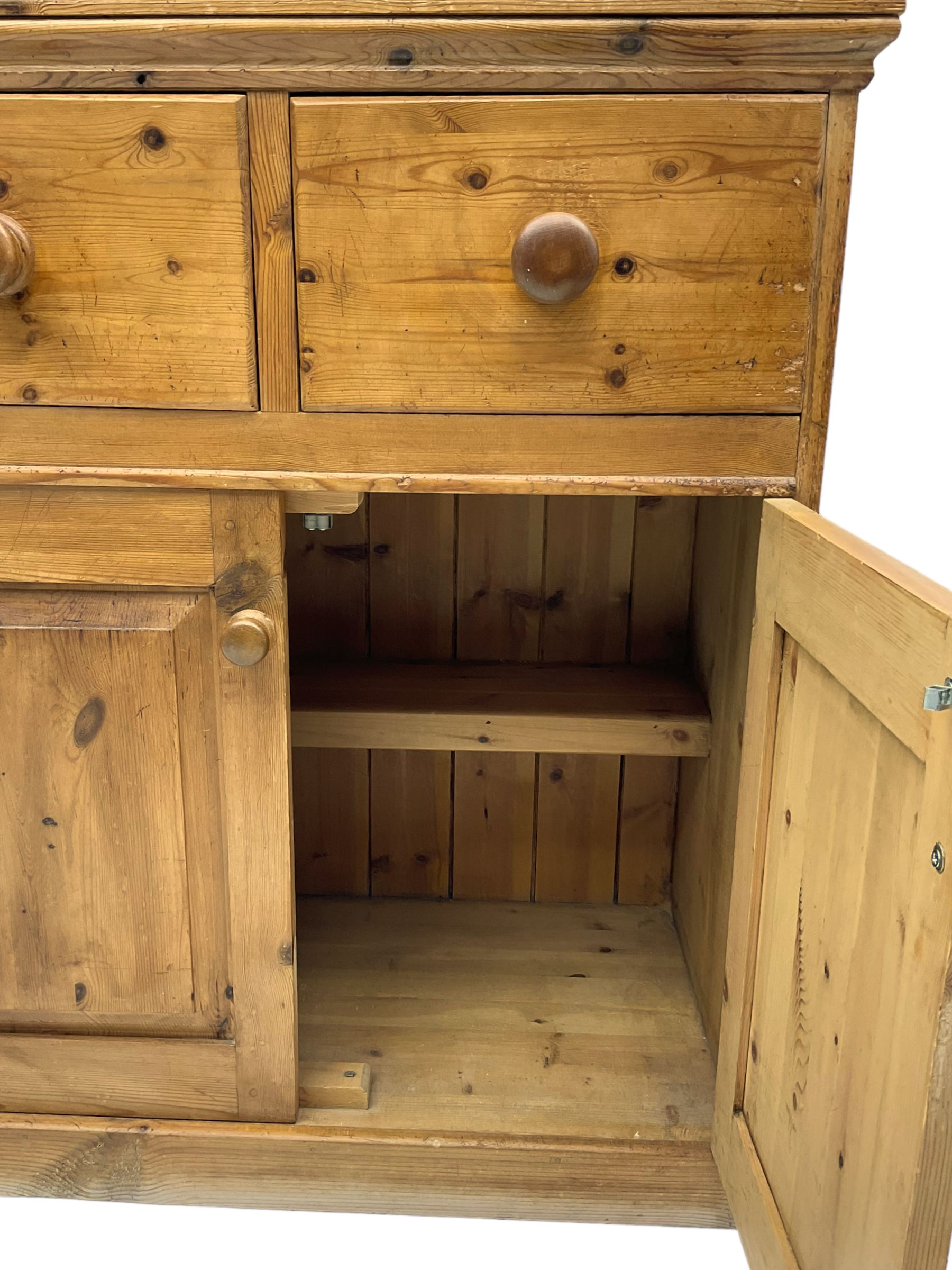 Solid pine dresser, fitted with plate rack above two drawers and two cupboards