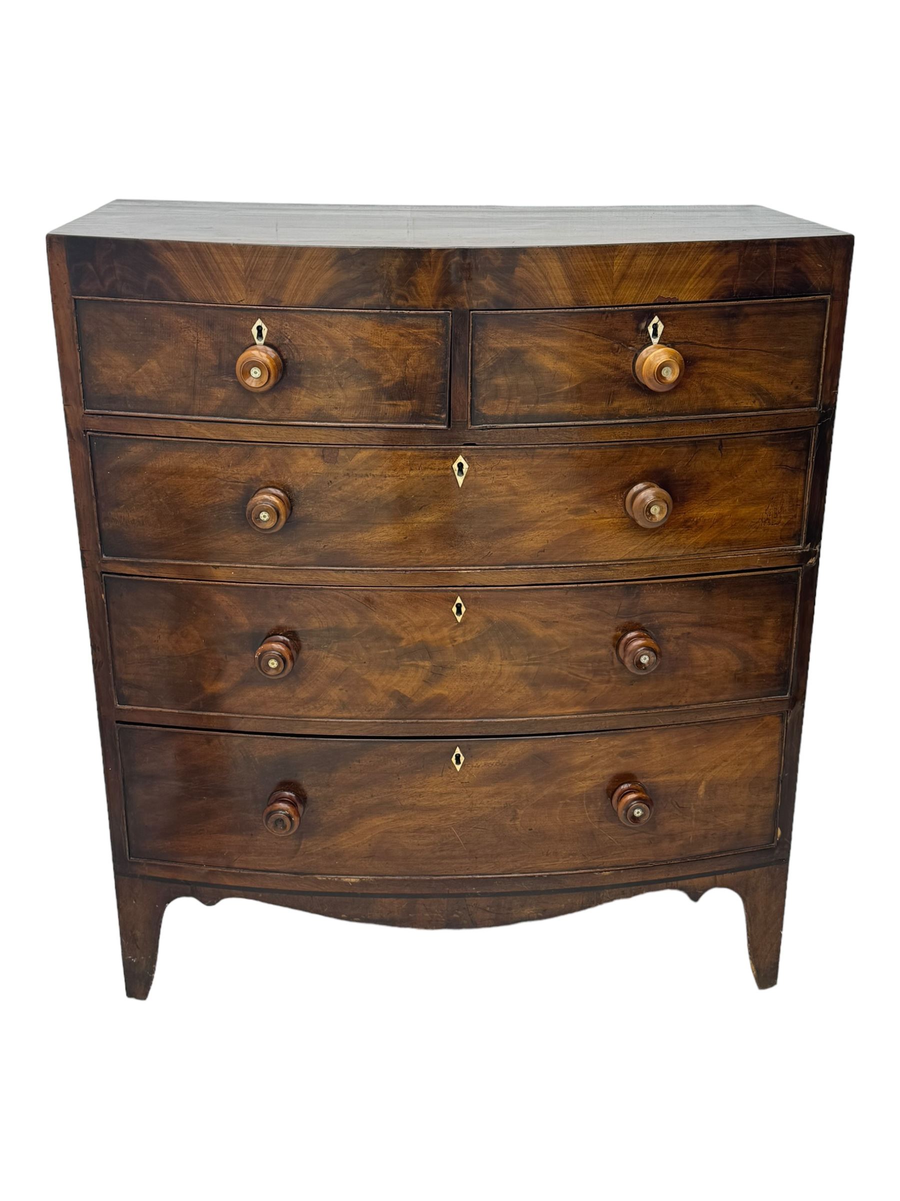 Early 19th century mahogany bow-front chest, fitted with two short over three long graduated cockbeaded drawers, each with turned wooden knobs and bone escutcheon, raised on splayed bracket supports