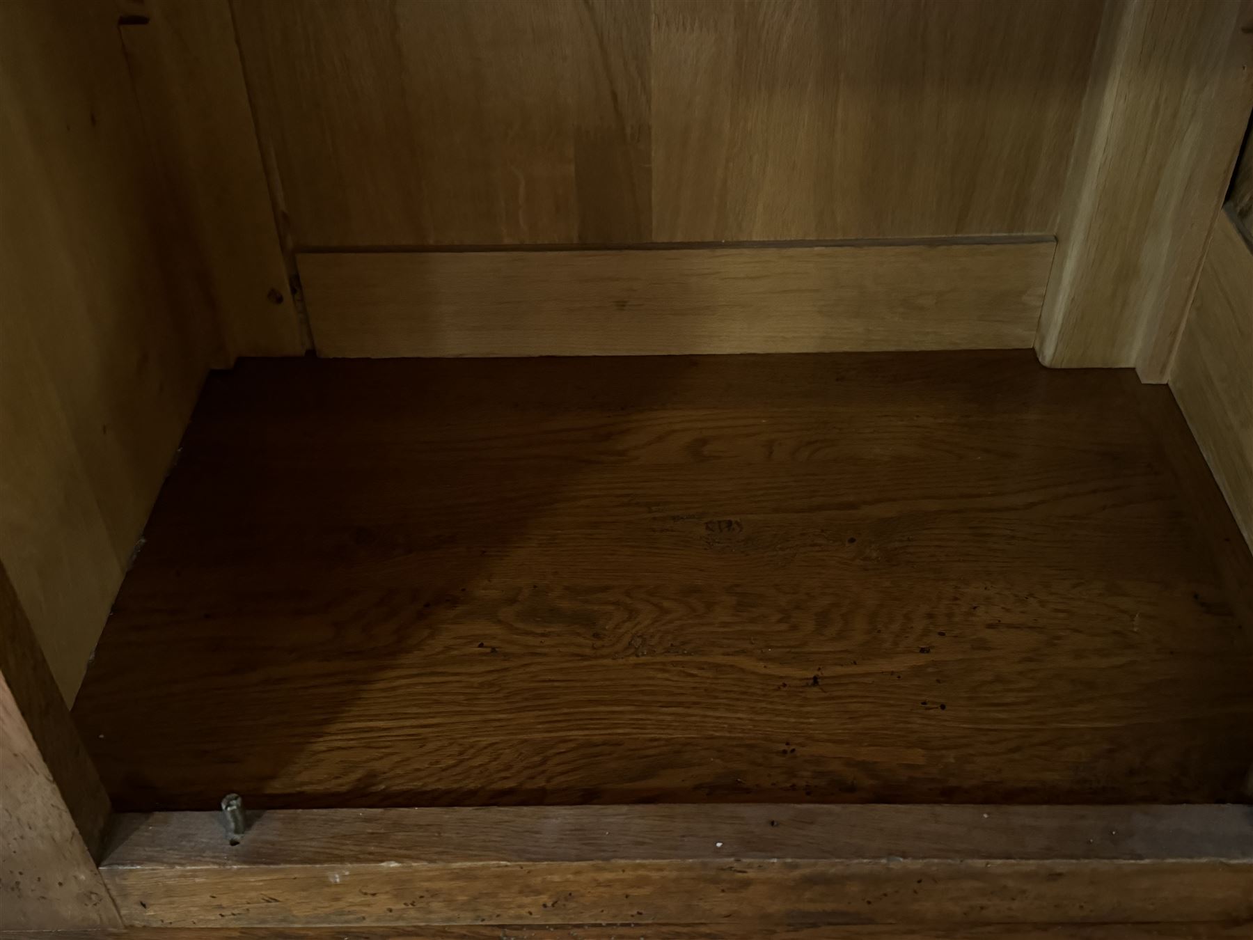 Large 20th century oak dresser, projecting cornice over open arched central section with two shelves, flanked by two panelled cupboards with two shelves, lower section with three drawers above three cupboards, on stile supports 