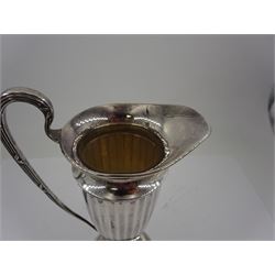 Early 20th century silver cream jug, of helmet form with faceted body and scroll handle, upon stepped circular foot, hallmarked Walker & Hall, date mark indistinct, H16.5cm