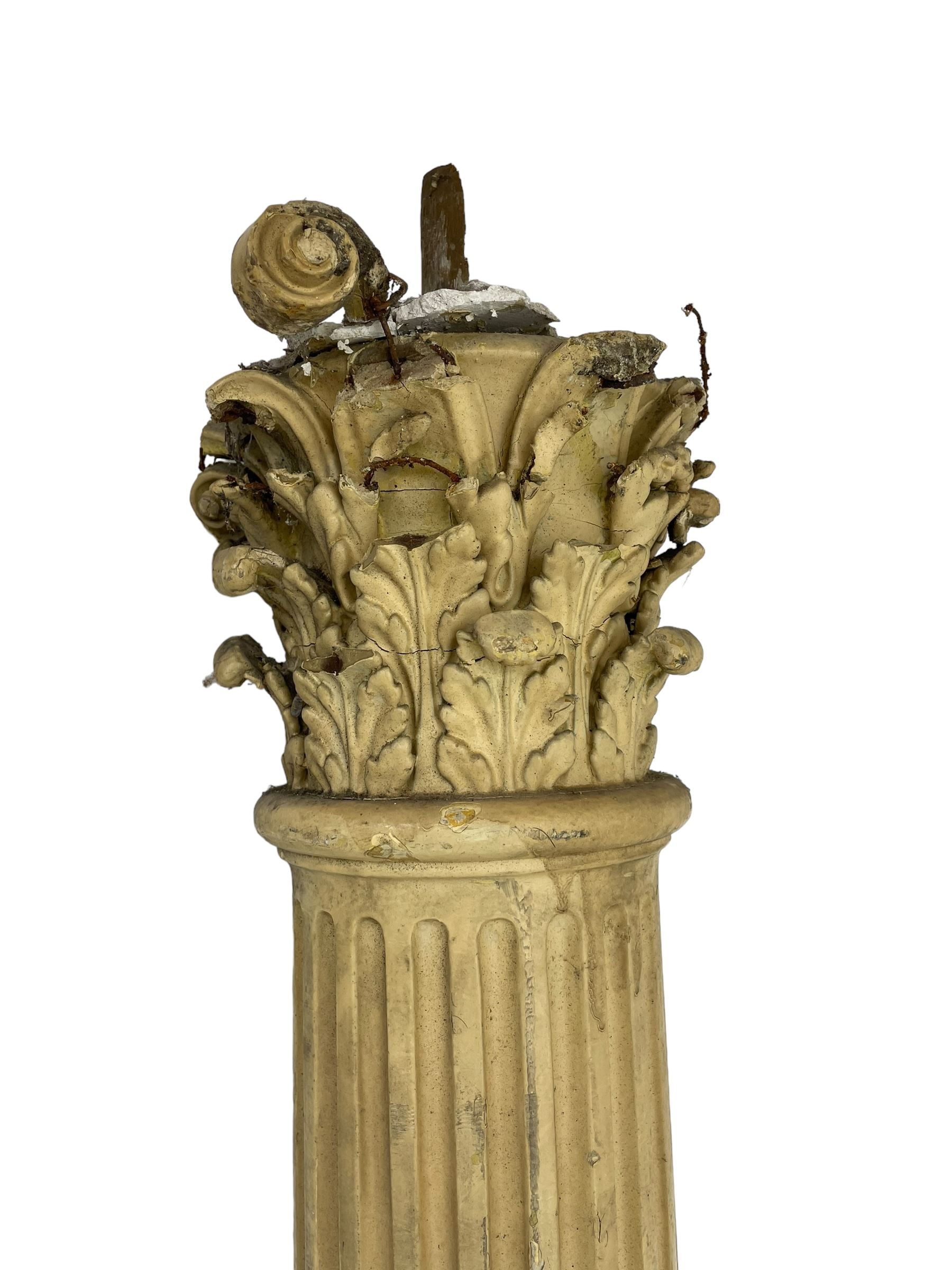 Three 19th century wood and gesso Composite order architectural architraves - curled acanthus leaf capitals over fluted shafts, the bases decorated with guilloche moulding over trailing laurel leaf branches, one half columns, one L-shaped rectangular pilaster and one full column, the largest - H204cm