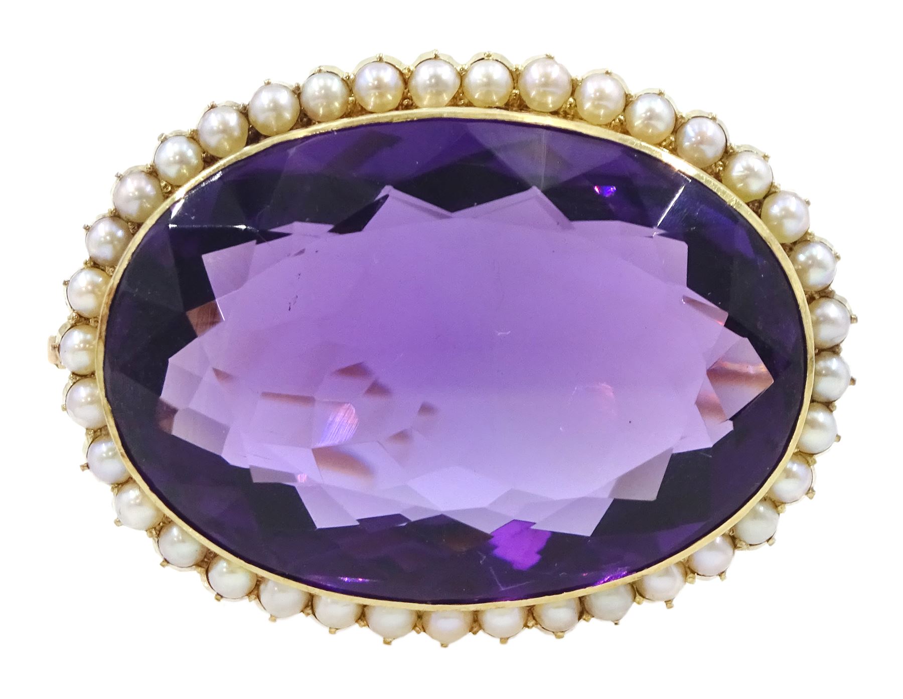 Early 20th century gold large oval cut amethyst and seed pearl brooch, stamped 15ct