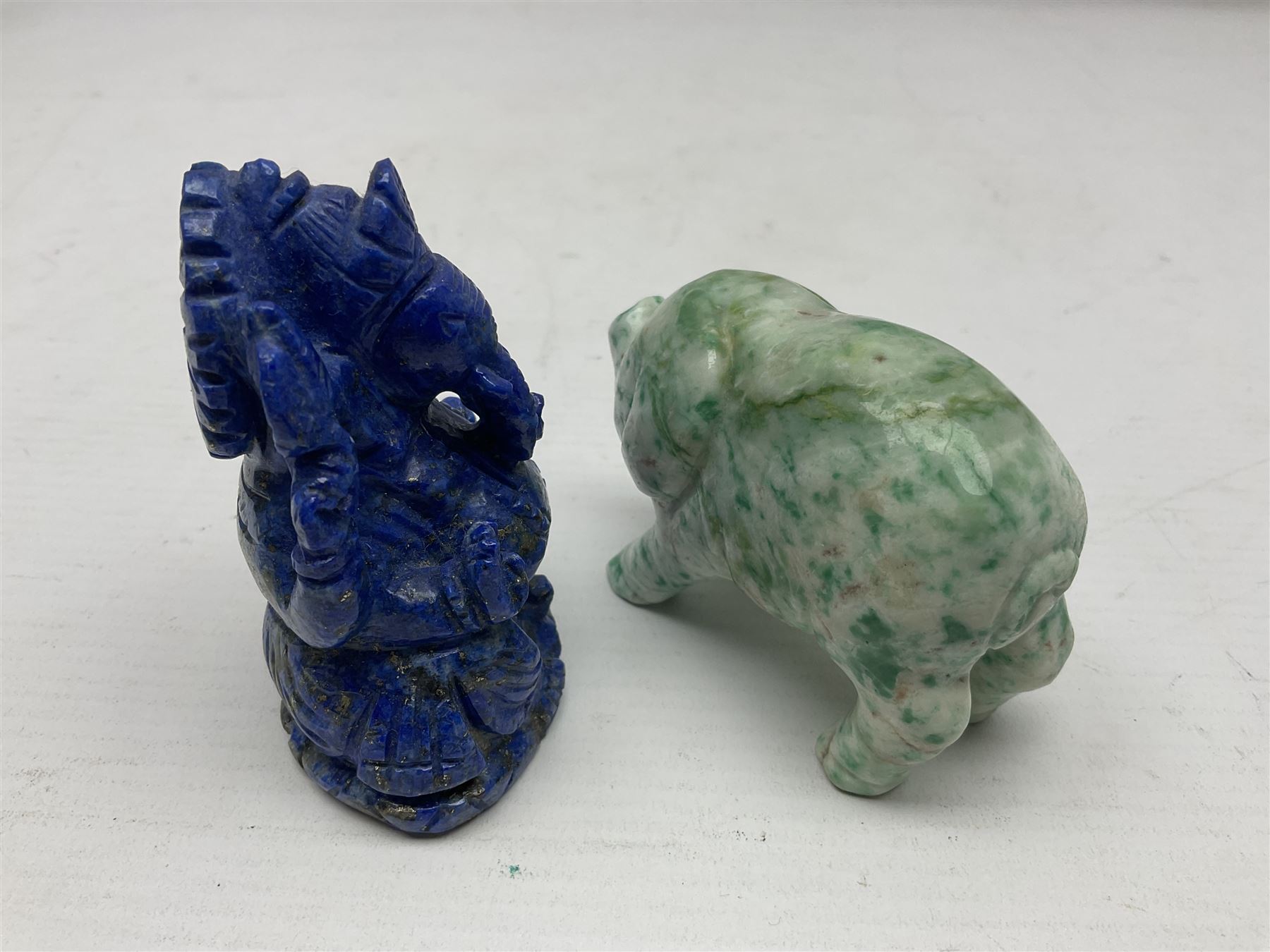 Carved Lapis lazuli figure in the form of Ganesha, together with turquoise carved buddha, tigers eye owl and other carved figures and plaques, Ganesha 8cm