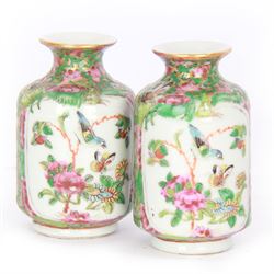 Pair of Chinese famille rose miniature vases, painted with panels depicting figures in a garden, with flora and fauna decoration, H10cm