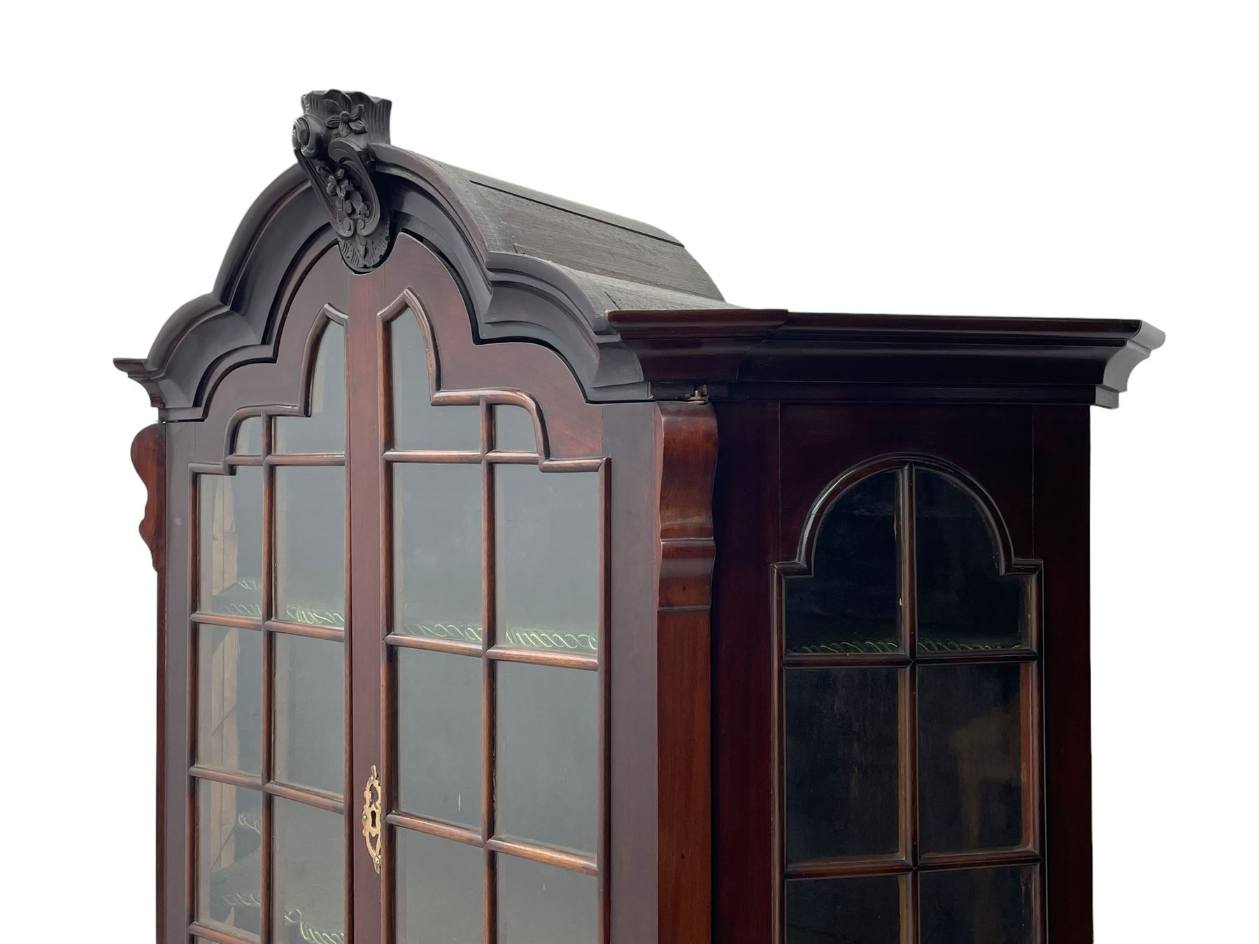 19th century Dutch mahogany vitrine on chest, shaped moulded pediment with central C-scroll and flowerhead carved mount, enclosed by two astragal glazed doors, the interior fitted with fabric lined shelves, four graduating long drawers below, on ball and claw carved feet 