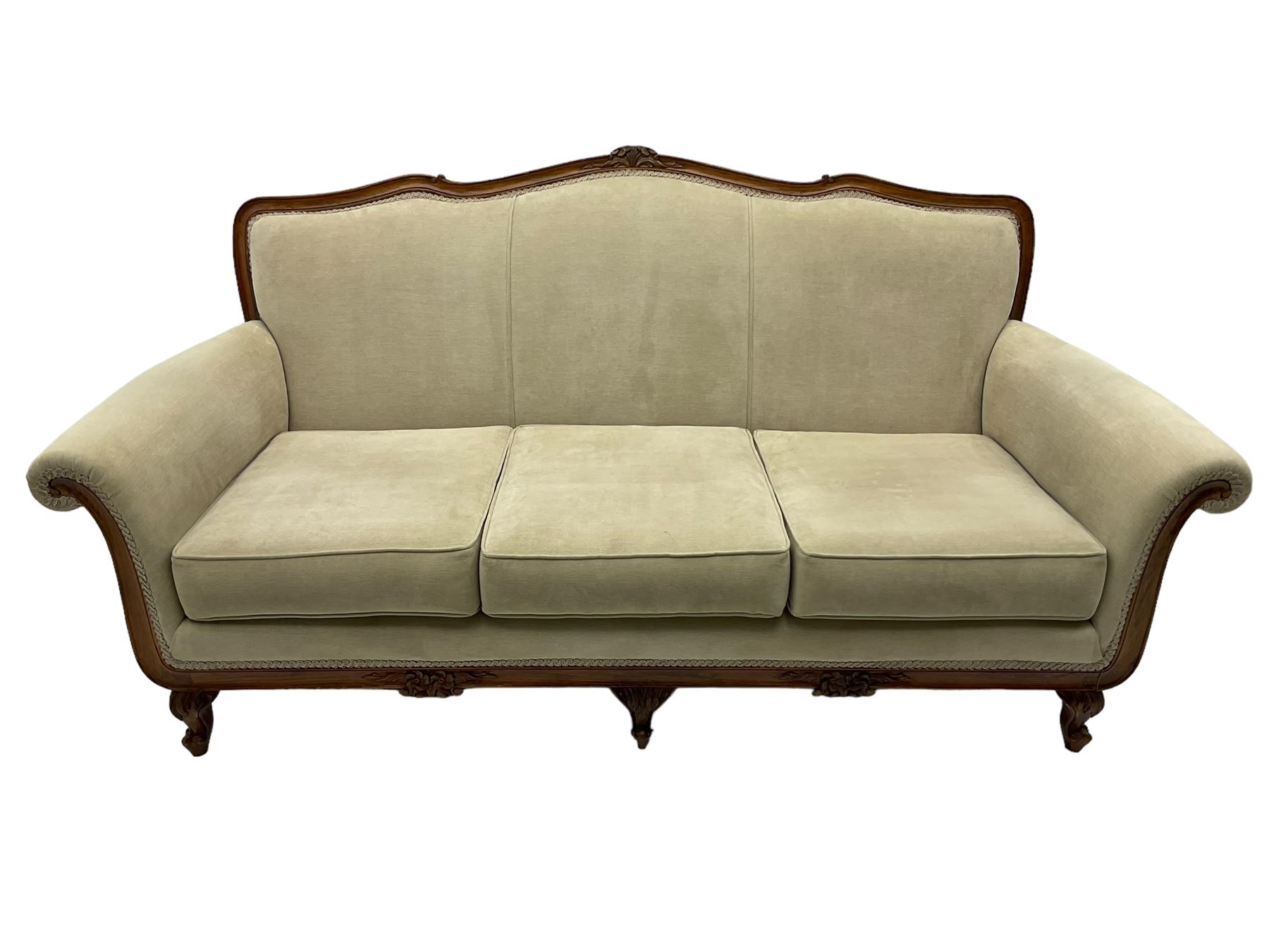 French design stained beech framed three-seat sofa, moulded frame carved with flowers and foliage, upholstered in pale neutral fabric, the moulded lower rail carved with flowerheads, on acanthus leaf carved cabriole feet