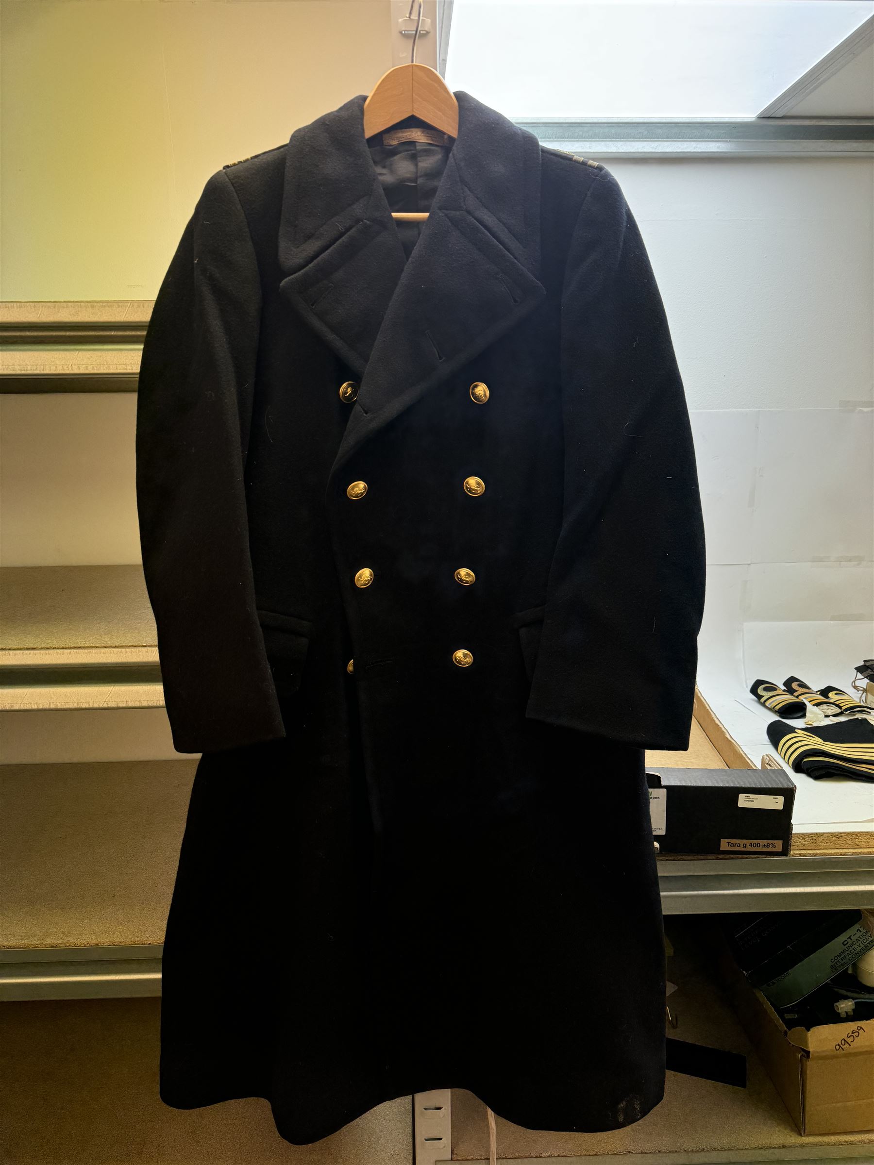 Royal Navy Lieutenant's Frock Coat by Haycock and Jarman, together with other naval accessories, including four pairs of Captain's insignia, six pairs of Captain's shoulder boards, a Merchant Navy cap badge and a collection of other badges, buttons and shoulder boards 