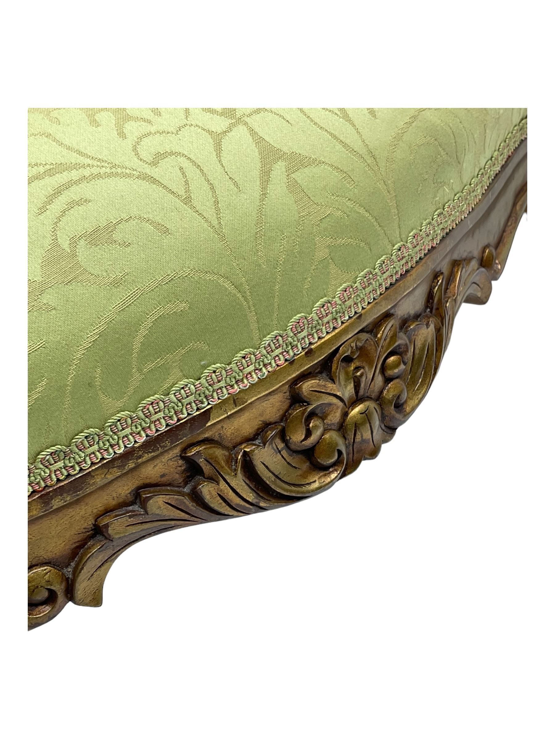 Late 20th century French design gilt framed armchair, upholstered in lime green damask fabric, arched back with carved crest, scroll arms, serpentine front rail, on cabriole front supports with ball feet