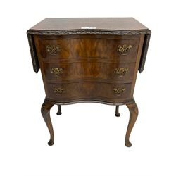 Early to mid-20th century figured walnut lamp table, shaped drop-leaf top with foliate carved edge, fitted with three drawers, on shell carved cabriole supports