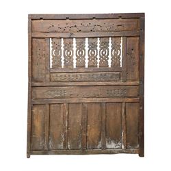 Early 20th century Javanese teak and hardwood door panel or room divider, rectangular panelled form with moulded frame and pegged construction, carved and pierced with scrolling decoration and flower head motifs, shaped and pierced splats with interlocking pattern