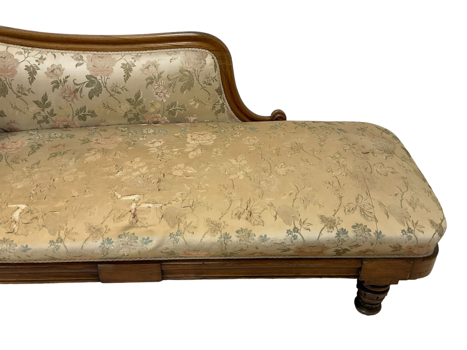 Victorian rosewood chaise longue, rolled back rest and shaped cresting rail carved with curled leaves and scrolls, upholstered in floral pattern fabric with bolster cushion, moulded lower rail with rectangular panel, on turned and lappet carved feet