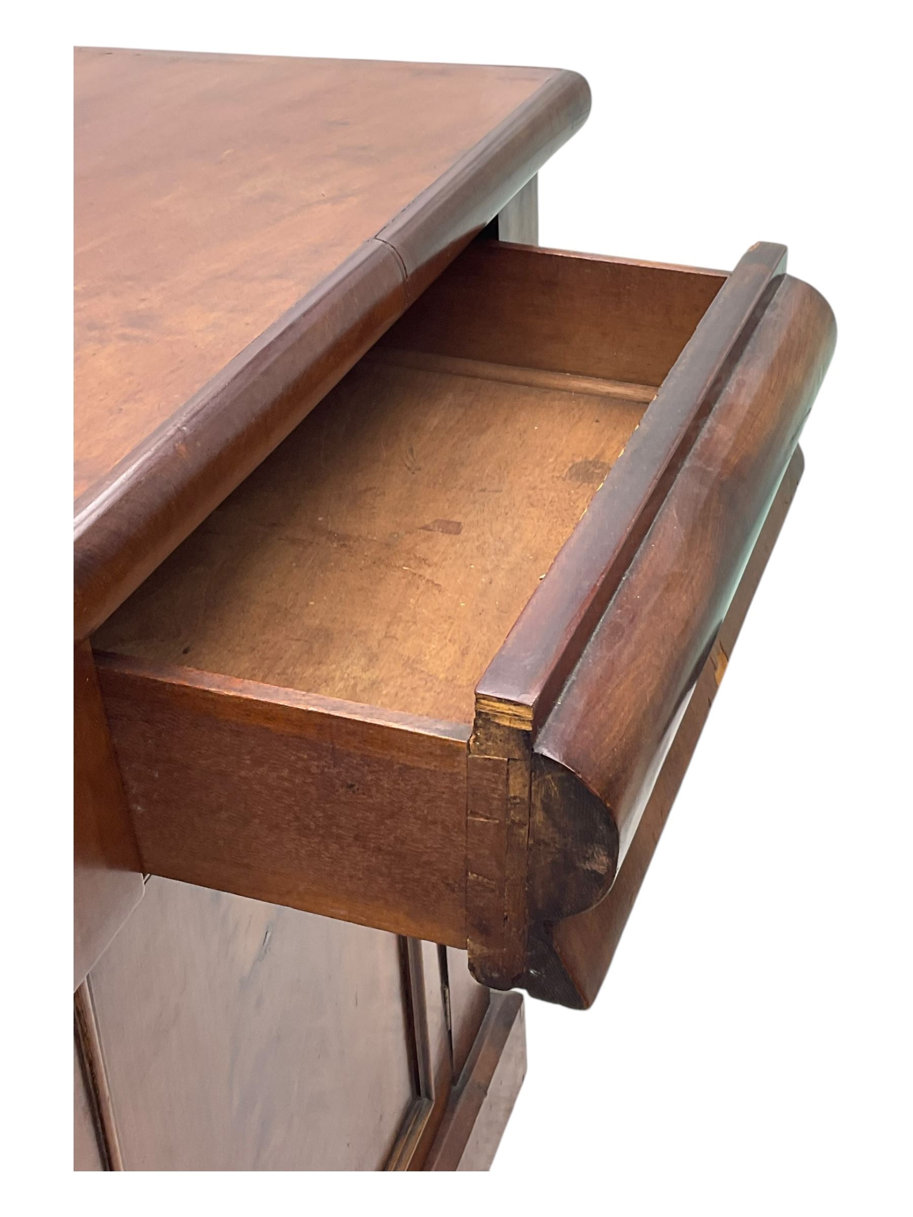 Mid 19th century mahogany sideboard, rectangular top over two frieze drawers with rounded edges, flanked by floral carved corbels, over two panelled cupboard doors, raised on a plinth base