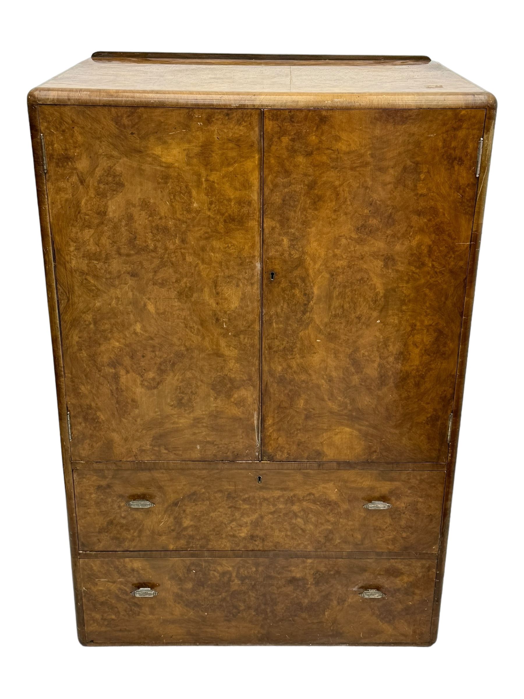 Early 20th century burr walnut cabinet, rectangular top with raised back, over double-door cupboard enclosing camphor interior with single shelf, lower section fitted with two drawers