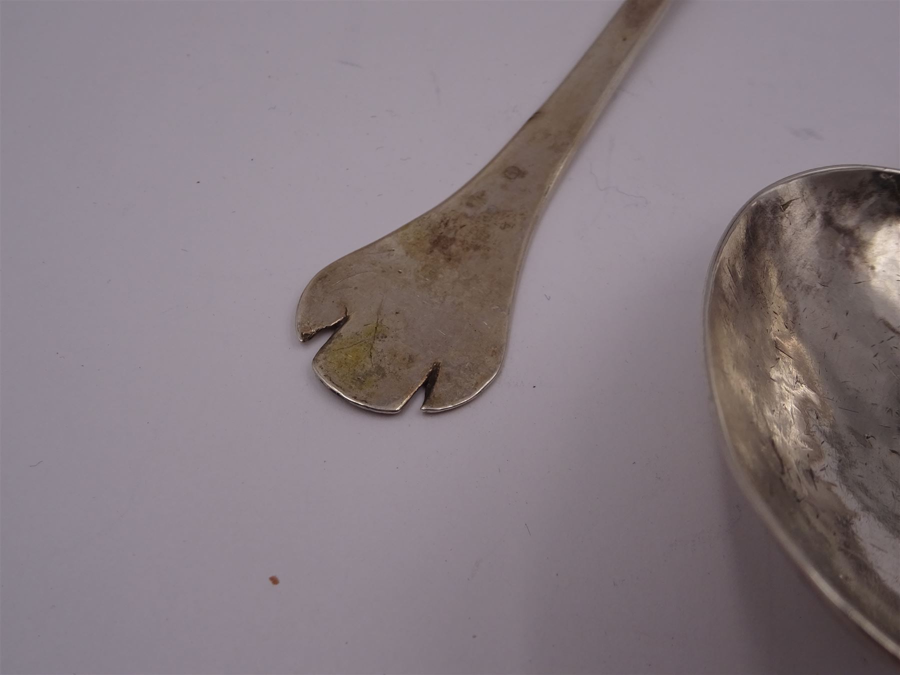 17th century silver trifid spoon, marks worn and indistinct, together with an Old English pattern silver spoon