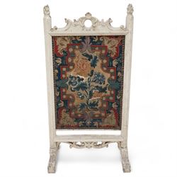 19th century carved wood fire screen, with lift-up tapestry panel, pierced pediment carved with C-scrolls and curled leaves, flanked by moulded uprights with torch finials, on scrolled out splayed feet 